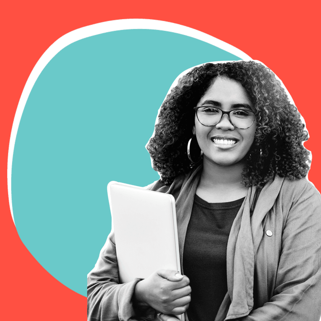 Black woman smiling and holding a laptop