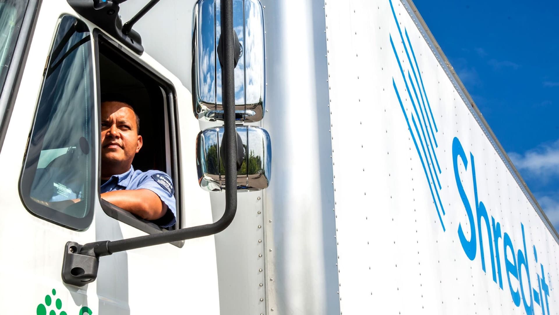 Driver in Shred-it Truck Window Looking Out